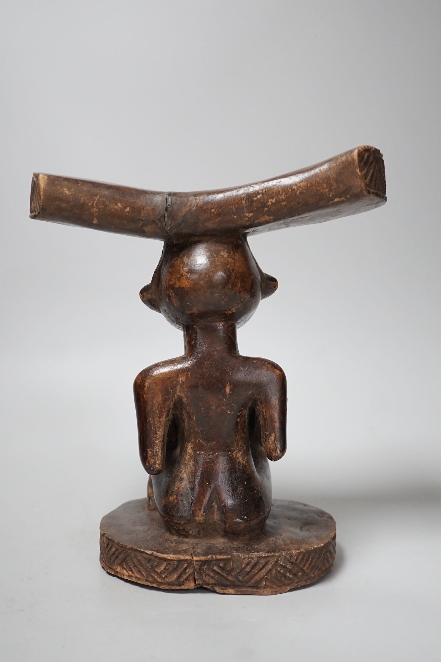 An African tribal carved wood fertility figure headrest, possibly Songye,. 24cm tall